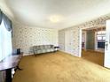 Inviting living room with large windows, patterned walls, and classic furniture at 701 Martin Luther King Dr., Andrews, SC 29510