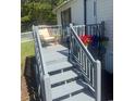 Inviting outdoor deck with comfortable seating and decorative plants, perfect for relaxation at 8404 Bloomwood Dr., Myrtle Beach, SC 29588