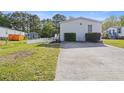 Spacious driveway leading to a home with a white fence, offering ample parking at 8404 Bloomwood Dr., Myrtle Beach, SC 29588