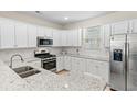 Well-equipped kitchen with stainless steel appliances, white cabinets, and granite countertops at 2250 Heritage Loop, Myrtle Beach, SC 29577
