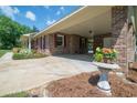 Spacious carport with brick pillars and a garden, adding charm to the home's exterior at 391 Waterford Dr., Georgetown, SC 29440