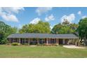 Charming brick home featuring a manicured lawn and a convenient covered carport at 391 Waterford Dr., Georgetown, SC 29440