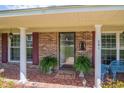 Inviting front entrance with brick accents, shutters, and a welcoming 'Welcome' mat at 391 Waterford Dr., Georgetown, SC 29440