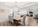 Elegant dining room with a chandelier, opening to a spacious living area and modern kitchen at 5000 Azul Loop, Myrtle Beach, SC 29579