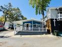 Charming blue beach house with a white picket fence and covered porch at 6001 - 1599 S Kings Hwy., Myrtle Beach, SC 29575