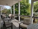Relaxing covered porch with comfortable seating and views of the green backyard at 69 Sea Level Loop, Pawleys Island, SC 29585