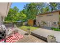 Private backyard with a deck, lush greenery, and additional storage building at 1021 Myrtle Dr., Surfside Beach, SC 29575
