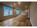 Bright living room features hardwood floors, recessed lighting, and large windows at 1213 Lady Bird Way, North Myrtle Beach, SC 29582