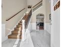 Inviting foyer with marble floors, elegant staircase with iron spindles, and arched doorway at 224 Je Edward Dr. # 17, Myrtle Beach, SC 29588