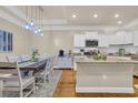 Spacious kitchen with granite counters, white cabinets, and an island; open to the dining area at 224 Je Edward Dr. # 17, Myrtle Beach, SC 29588