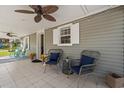 Inviting screened-in porch with ceiling fans, comfortable seating, and tiled flooring for outdoor enjoyment at 319 Sparrow Dr., Surfside Beach, SC 29575
