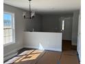 Bright living room with a modern chandelier and newly painted walls, offering a welcoming atmosphere at 8050 Mill Pond Rd., Galivants Ferry, SC 29544