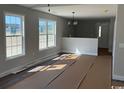 Bright living room featuring ample natural light from large windows and freshly painted walls at 8050 Mill Pond Rd., Galivants Ferry, SC 29544