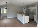 Open-concept kitchen featuring an island with granite countertops and white cabinetry at 8054 Mill Pond Rd., Galivants Ferry, SC 29544