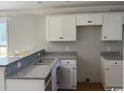 Kitchen featuring white cabinets, granite countertops, and stainless steel sink at 8058 Mill Pond Rd., Galivants Ferry, SC 29544
