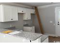 Kitchen featuring white cabinets, granite countertops, and modern fixtures at 8058 Mill Pond Rd., Galivants Ferry, SC 29544