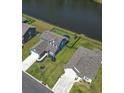 Aerial view showcases the home's backyard bordering a pond, surrounded by lush landscaping and neighboring houses at 897 Wild Leaf Loop, Conway, SC 29526