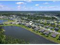 Community aerial view of the homes, pond, and streets in the neighborhood with treed perimeter at 897 Wild Leaf Loop, Conway, SC 29526
