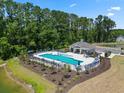 Beautiful community pool with lounge chairs and umbrellas, perfect for relaxation and recreation at 1222 Nw Calabash Station Blvd., Calabash, NC 28467
