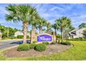 Welcome to Wellington: A beautiful community entrance with palm trees at 121 Olde Towne Way # 2, Myrtle Beach, SC 29588