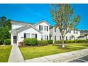 Inviting two-story condo with black shutters and a well-maintained lawn at 121 Olde Towne Way # 2, Myrtle Beach, SC 29588