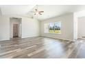 Bright bedroom with hardwood floors, a large window offering a lovely view, and ensuite bathroom access at 1233 Cypress Shoal Dr., Conway, SC 29526