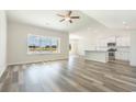Spacious living room with hardwood floors, large windows, and seamless open layout to kitchen at 1233 Cypress Shoal Dr., Conway, SC 29526