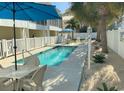 Community pool featuring a clear blue swimming pool, lounge chairs, and patio furniture at 1516 Edge Dr. # 101, North Myrtle Beach, SC 29582