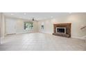 Spacious living room featuring tile floors, a cozy fireplace and natural light at 1623 27Th Ave. N, North Myrtle Beach, SC 29582