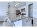 Bright kitchen with granite counters, stainless steel appliances, and a pantry, perfect for modern living at 202 Landing Rd. # B, North Myrtle Beach, SC 29582