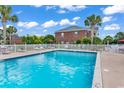Outdoor community pool area with lounge chairs and palm trees providing a relaxing atmosphere at 2037 Silvercrest Dr. # 16E, Myrtle Beach, SC 29579