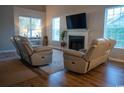 Cozy living room with a fireplace, natural light, and comfortable seating at 2039 Chadbury Ln., Myrtle Beach, SC 29588