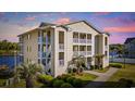 Condominium with nice landscaping, multiple balconies and water view during sunset at 214 Landing Rd. # I, North Myrtle Beach, SC 29582