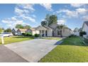 Inviting single-story home with a concrete driveway, lush green lawn, and charming curb appeal at 3012 Sabal Ct., Murrells Inlet, SC 29576
