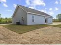 This is a view of the home's backyard with newly laid grass and light blue vinyl siding at 3415 B And S Rd., Loris, SC 29569