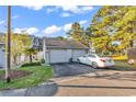 Detached two-car garage with a paved driveway, complemented by a well-maintained lawn and landscaping at 4006 Fairway Lakes Dr. # 4006, Myrtle Beach, SC 29577