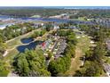 Breathtaking aerial view showcases the community with ponds, golf course, and marsh views at 4325 Deer Run Ave., Little River, SC 29566