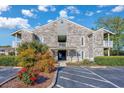 Exterior shot of a two-story condominium building with brick facade, pergola, and landscaped garden at 4712 Cobblestone Dr. # K-7, Myrtle Beach, SC 29577