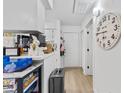 A well-lit galley kitchenette featuring white cabinets, a breakfast bar with seating, and updated appliances at 4712 Cobblestone Dr. # K-7, Myrtle Beach, SC 29577