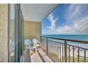 Relaxing ocean view from a private balcony with comfortable seating. Enjoy the calming scenery at 4800 S Ocean Blvd. # 708, North Myrtle Beach, SC 29582