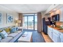 Cozy living room with ocean view and access to a private balcony, plus a convenient kitchenette at 4800 S Ocean Blvd. # 708, North Myrtle Beach, SC 29582
