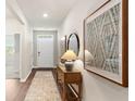 Inviting entryway with wood floors, console table, stylish decor, and a view to other rooms at 481 Blissful Ln., Little River, SC 29566