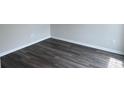 Durable and stylish gray hardwood flooring in a well-lit room at 484 Honeyhill Loop, Conway, SC 29526