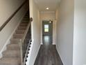 Inviting foyer with staircase, leading to a bright and open living space with hardwood flooring at 484 Honeyhill Loop, Conway, SC 29526
