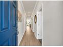 Inviting hallway featuring hardwood floors, neutral walls, and modern lighting fixtures at 500 Honeyhill Loop, Conway, SC 29526
