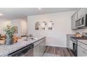 Stylish kitchen featuring granite countertops, stainless steel appliances, and light gray cabinetry at 504 Blissful Ln., Little River, SC 29566
