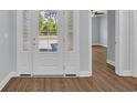 Close up of front door opening into entryway with consistent flooring throughout home at 5132 Little River Neck Rd., North Myrtle Beach, SC 29582