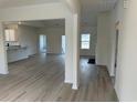 Bright and spacious living space with hard wood floors, featuring an open floor plan and ample natural light at 553 Honeyhill Loop, Conway, SC 29526