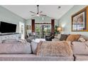 Spacious living room with comfortable seating, a ceiling fan, and a large sliding glass door that opens to a private balcony at 5750 Oyster Catcher Dr. # 1135, North Myrtle Beach, SC 29582