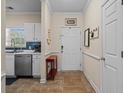Kitchen doorway with stainless steel appliances and entryway with a table and decor at 6015 Catalina Dr. # 132, North Myrtle Beach, SC 29582